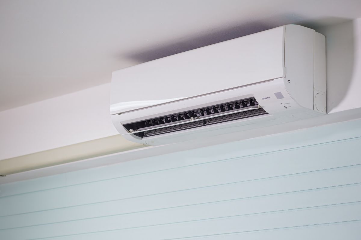 Wall-mounted ductless mini-split indoor unit installed near the ceiling of a home.